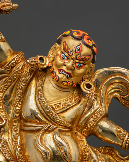 Close-up of Dorje Drolo Statue highlighting the fierce gold-painted face, wrathful expression, Vajra weapon, and detailed Newari artistry.