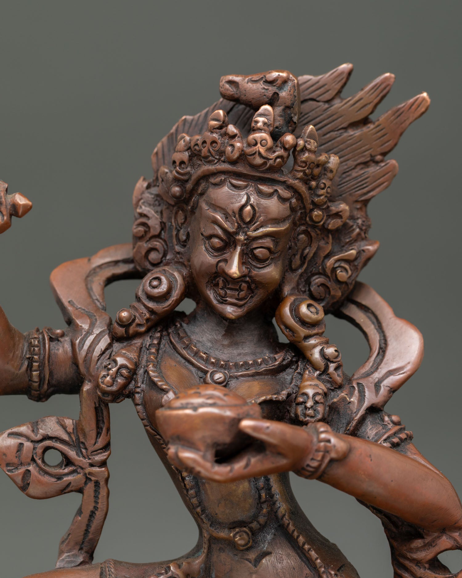 Close up of Dorje Phagmo statue wrathful expression holding kartika knife and kapala.