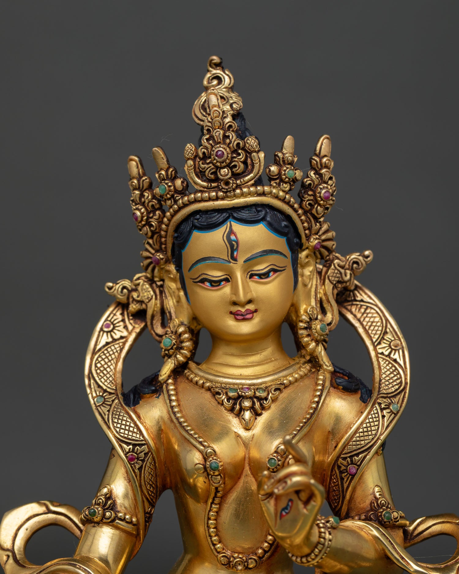Close-up of Dukkar statue with gold-gilded ornaments and lotus throne, handcrafted Nepal