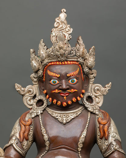 Close up of Dzambhala holding mongoose and citron fruit with hand-painted acrylic details