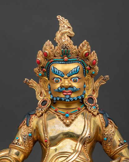Close up of Dzambhala statue holding a mongoose and citron, handcrafted in Nepal