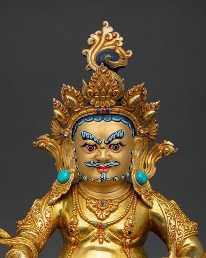 Close-up of Dzambhala Statue showing gold-painted face, intricate crown, and semi-precious stone details by Newari artisans