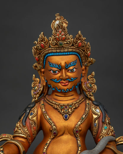 Close up of Dzambhala Statue showing intricate gold-gilded copper detailing
