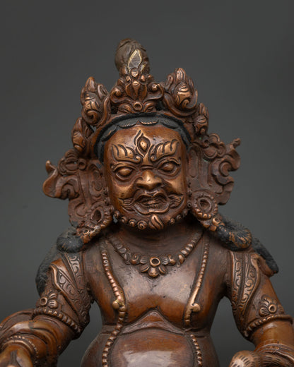 Close Up of Dzambhala Statue with Detailed Crown Jewelry and Floral Garment.