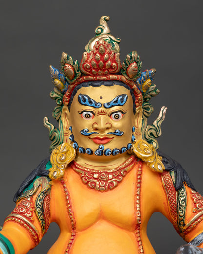 Close up of Dzambhala wealth god statue with piercing eyes and vibrant acrylic finishes