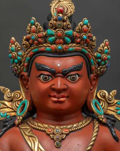 Close-up of Dzambhala's face – hand-painted Nepalese Buddhist wealth deity statue detail