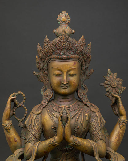 Close up of Four Armed Chenrezig face with antique oxidized copper finish and detailed crown.