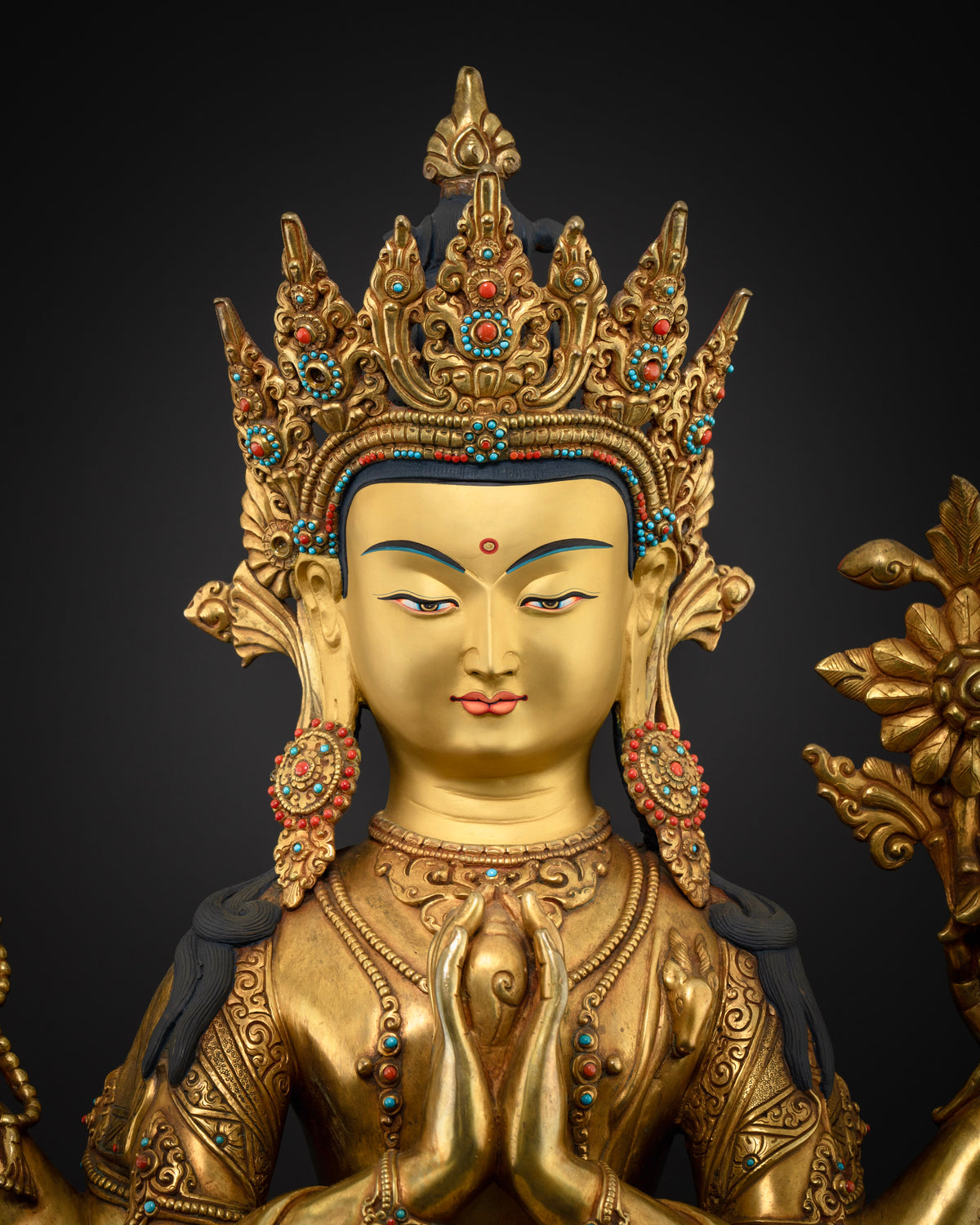 Close-up of Four-Armed Chenrezig statue, gold fire-gilded copper Buddhist sculpture