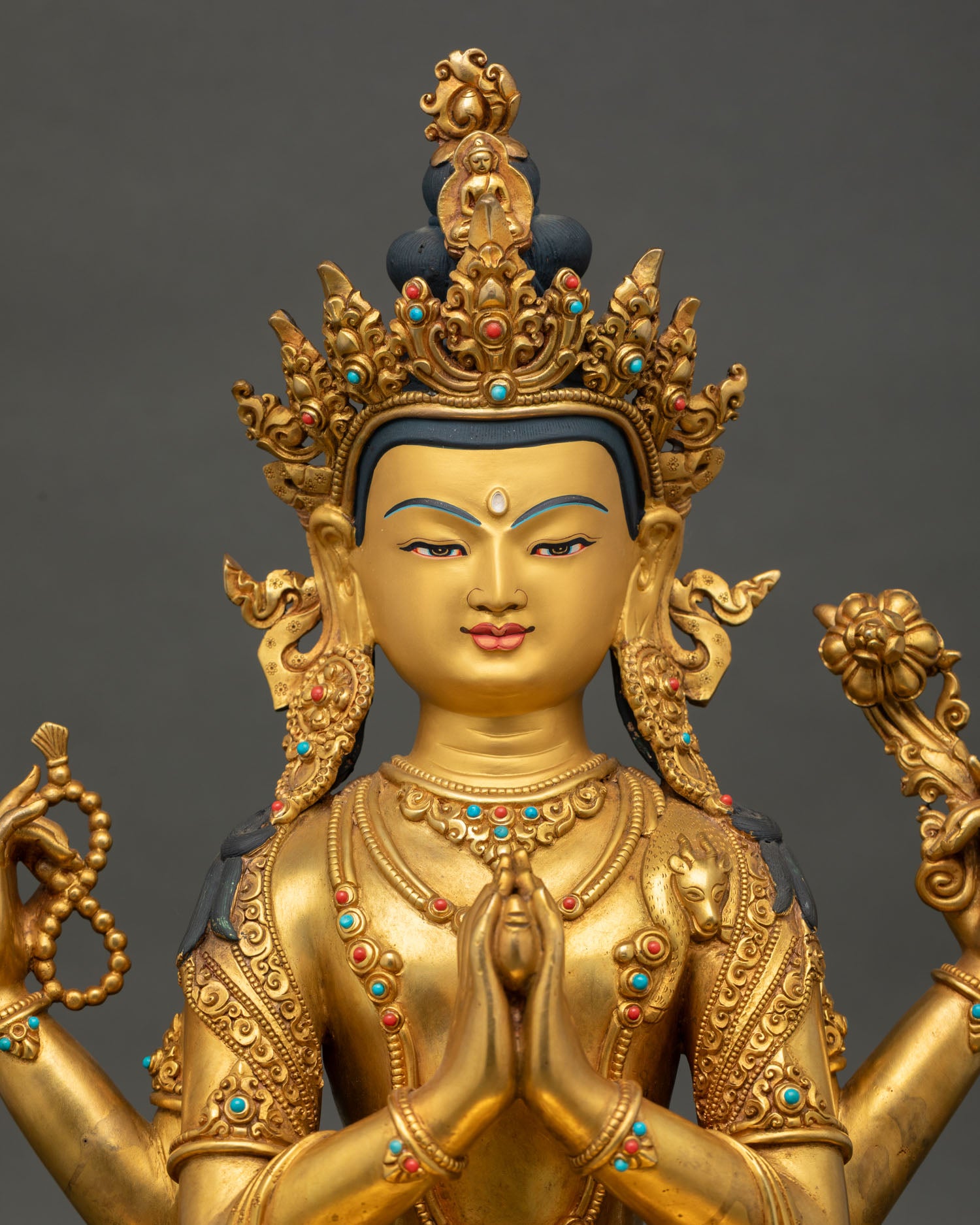 Close-up of Four-Armed Chenrezig Statue with fire-gilded copper and semi-precious stone details