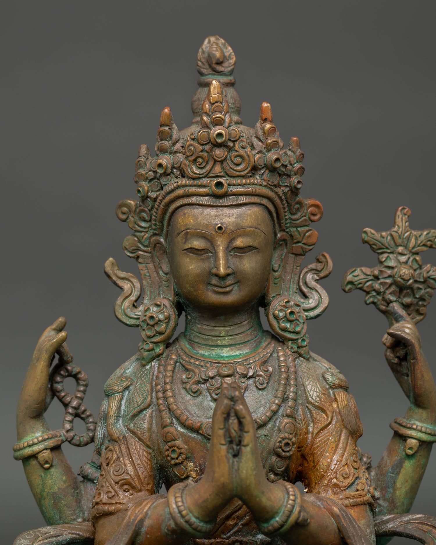 Close-up of Four-Armed Chenrezig Statue with oxidized copper and intricate details