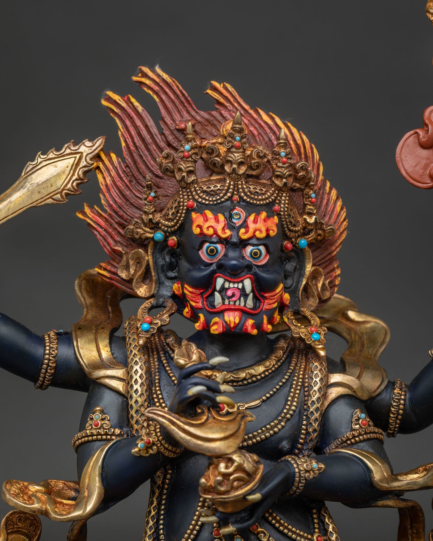Close up of Four Armed Mahakala statue showing hand painted wrathful face
