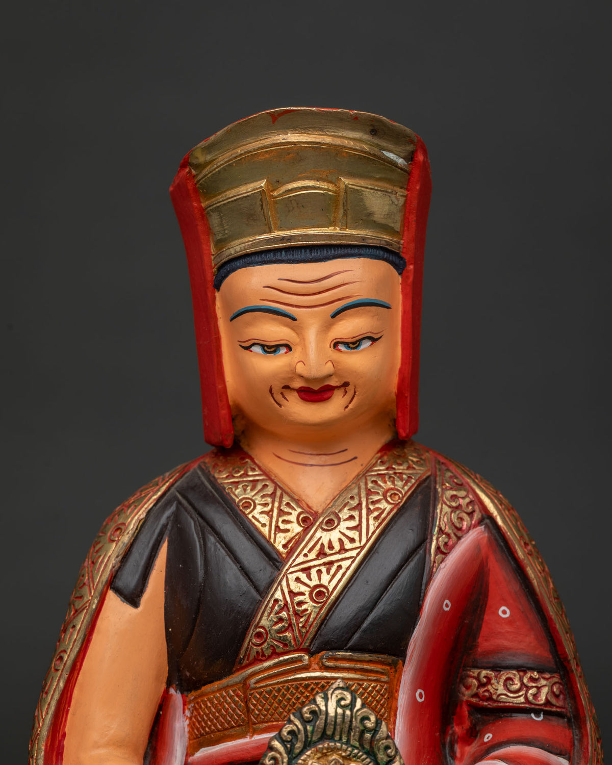 Close up of Gampopa statue holding a flaming jewel, handcrafted in Nepal from copper