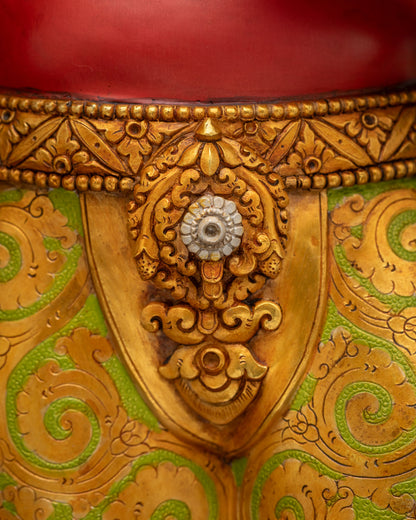 Close-up of Ganesha statue belt buckle with green and gold floral pattern