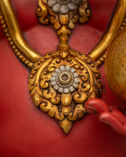 Close-up of Ganesha statue chest necklace with round gold gemstone medallion