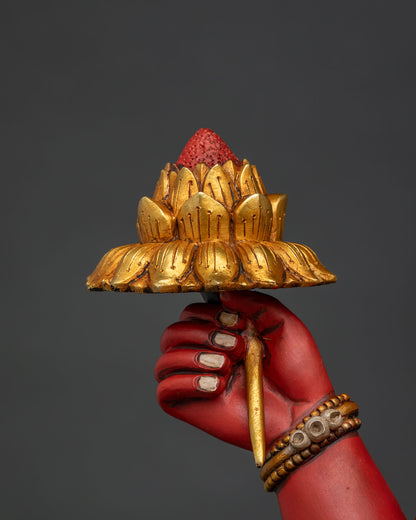 Close-up of Ganesha statue hand holding gold lotus flower, Newari repousse work