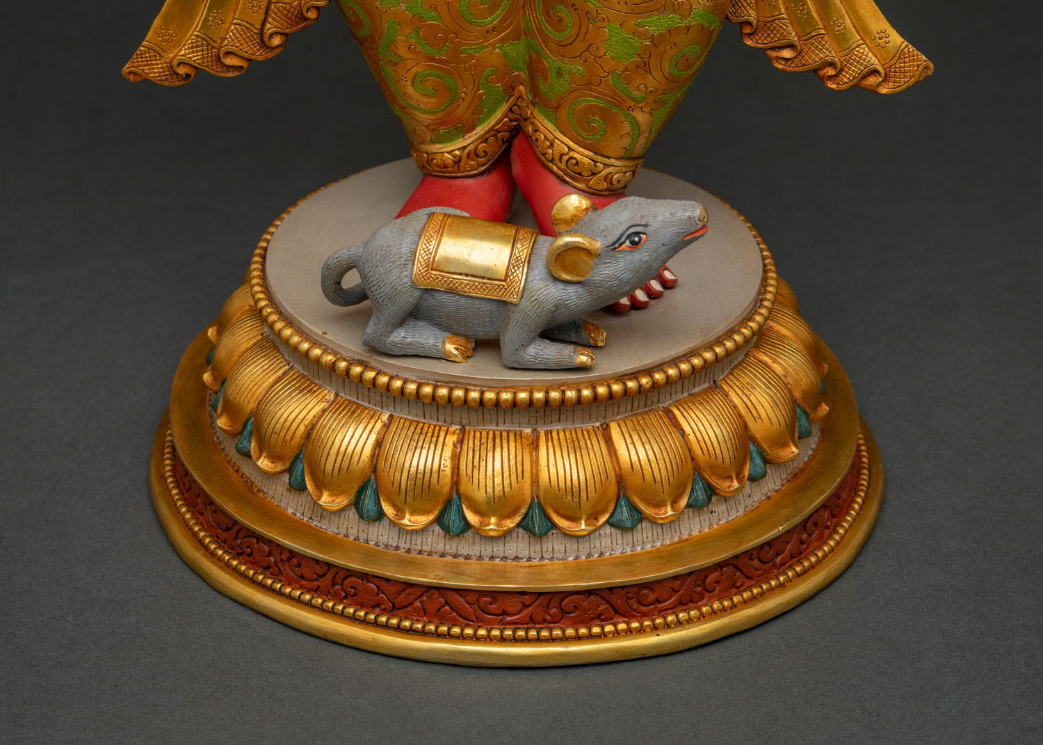Close-up of Ganesha statue lotus pedestal base with Mushika mouse figure