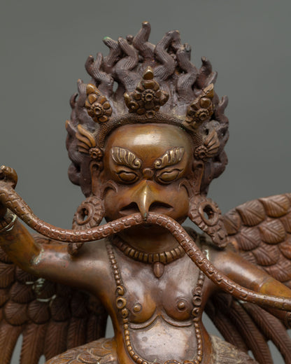 Close up of Garuda sculpture showing detailed wings talons and fierce protective expression