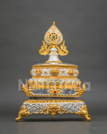 Close-up of gold and silver plated Mandala Offering Set with auspicious Buddhist symbols