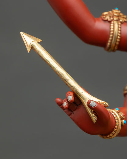 Close-up of gold arrow held by Four-Armed Maha Manjushri statue