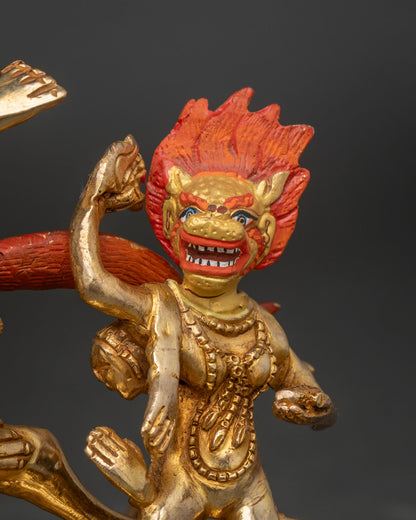 Close-up of gold attendant with open mouth and raised arm on Palden Lhamo statue base