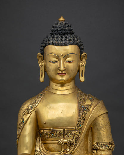 Close up of gold fire-gilded Shakyamuni Buddha Statue with lotus pedestal