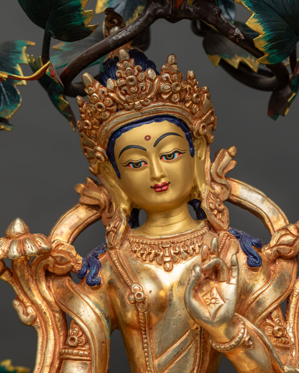 Close-up of gold gilded Green Tara face and ornate crown, 21 Tara Statue Set