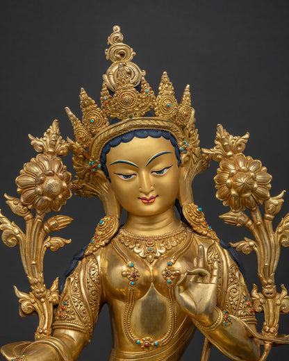 Close-up of gold-gilded Green Tara statue featuring hand-set turquoise and coral gemstones