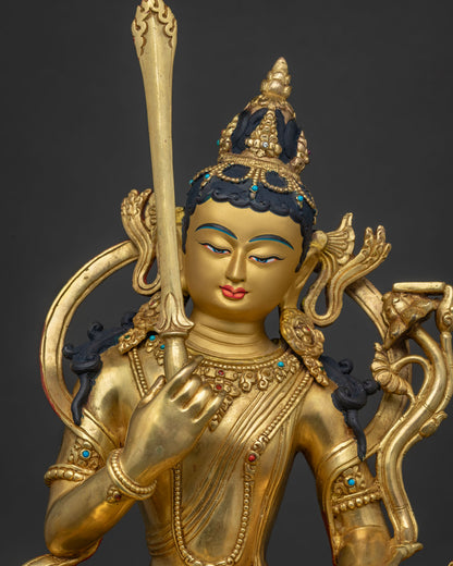 Close-up of gold-gilded Manjushri Statue with fine Tibetan metalwork and gemstone inlays