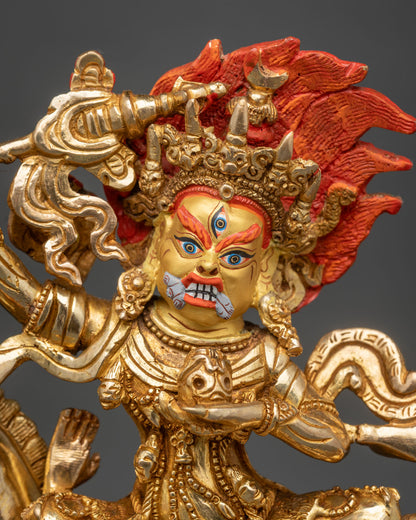 Close-up of gold Palden Lhamo face with third eye, flame-red hair, and bared fangs