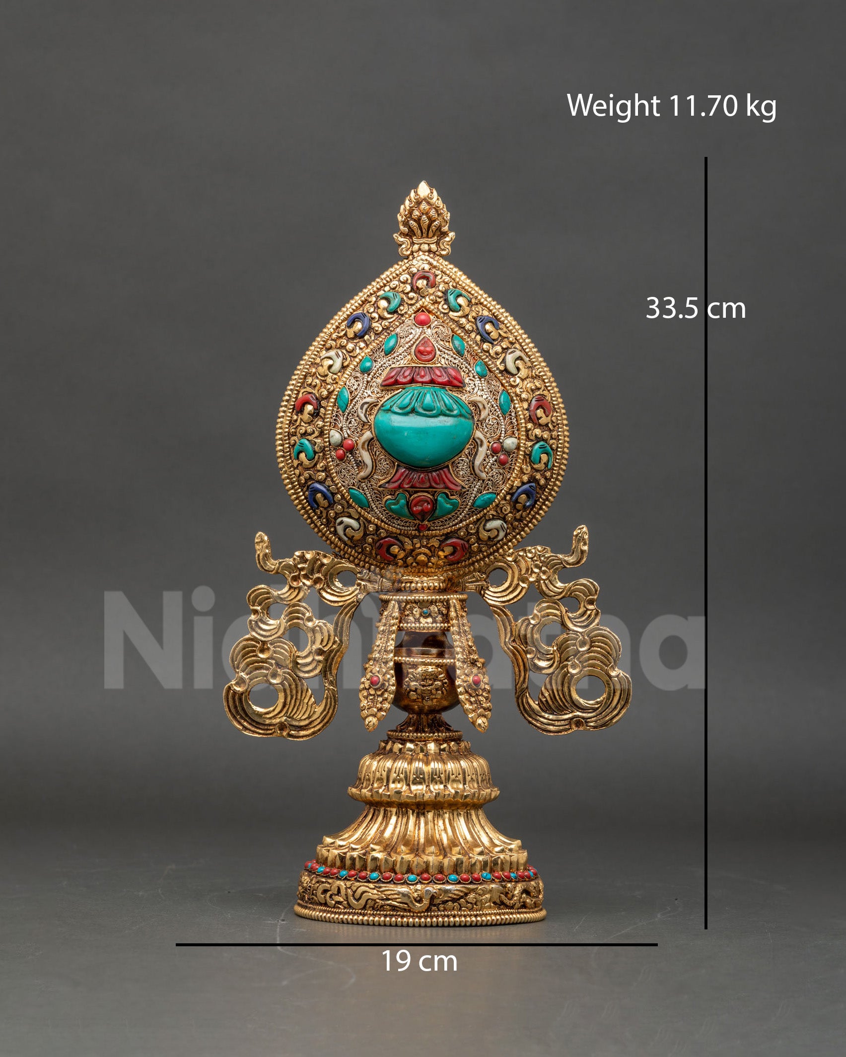 Close-up of gold-plated copper Astamangala Buddhist symbols adorned with semi-precious stones, intricate Newari metalwork craftsmanship.