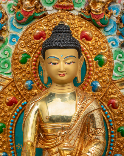 Close-up of gold Shakyamuni Buddha face with blue urna and snail-shell curls, Newari metalwork