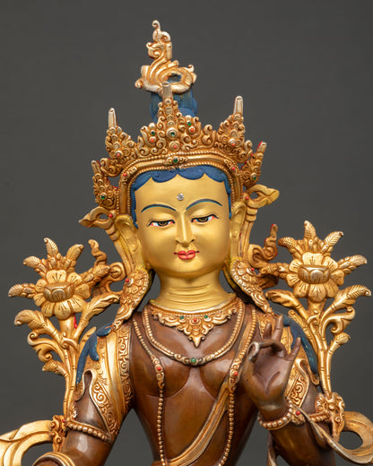 close-up of green tara bodhisattva face with gold gilding and intricate details