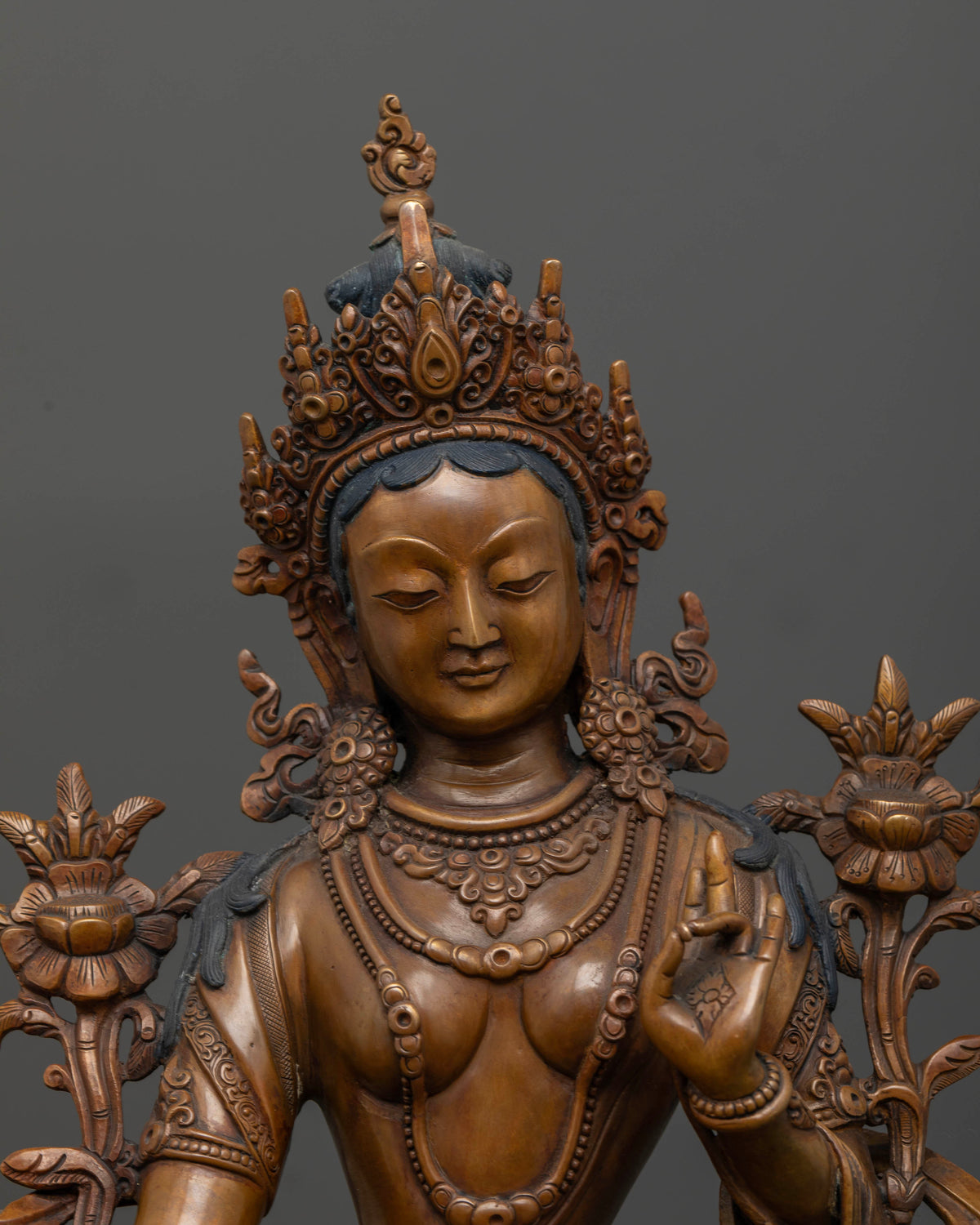 Close up of Green Tara Bodhisattva showing intricate Nepalese copper craftsmanship