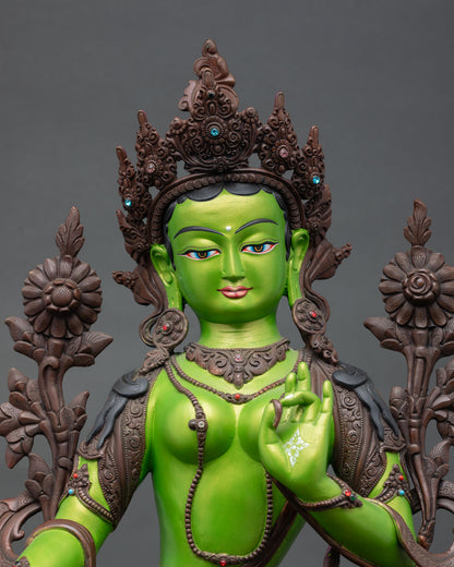 close up of green tara buddhist statue with hand-painted crown and gemstone accents