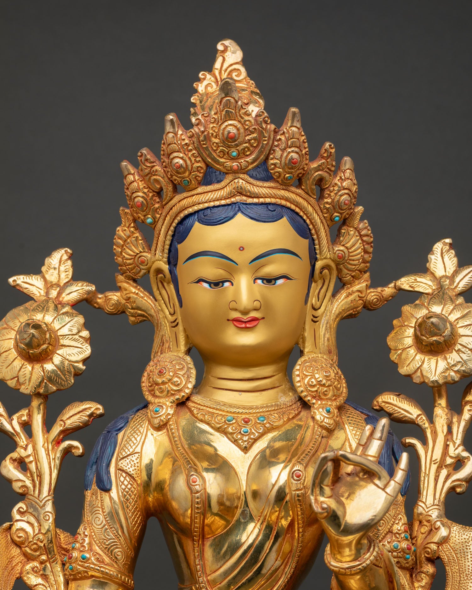 Close up of Green Tara Buddhist statue with semi precious stones and intricate Newari craftsmanship