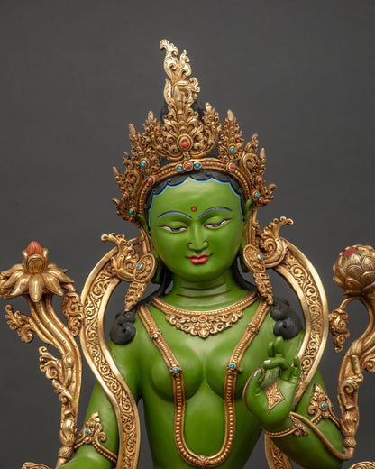 Close-up of Green Tara copper statue seated in Lalitasana with jewel crown and gold gilding