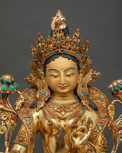 Close up of Green Tara face with 24K gold finish and compassionate expression