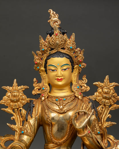 Close-up of Green Tara face with five-jeweled crown and fire-gilded finish.
