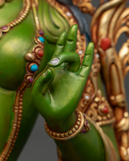 Close-up of Green Tara hand gesture with hand-painted fingers and silver-tipped nails