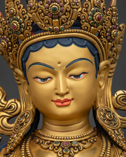 Close-up of Green Tara statue's gold-painted face with gentle serene expression