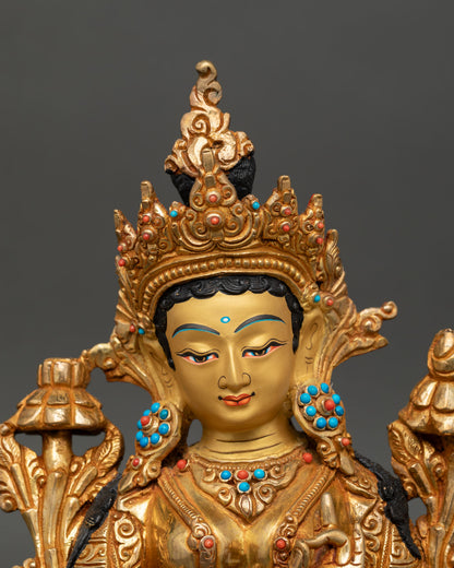 Close up of Green Tara statue serene gold painted face handcrafted Nepal