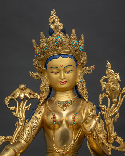 Close up of Green Tara Statue showing gold fire gilding and lotus pedestal detail