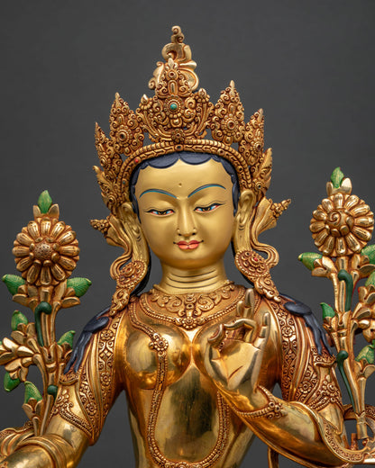 Close-up of Green Tara statue showing gold gilding and crown detail