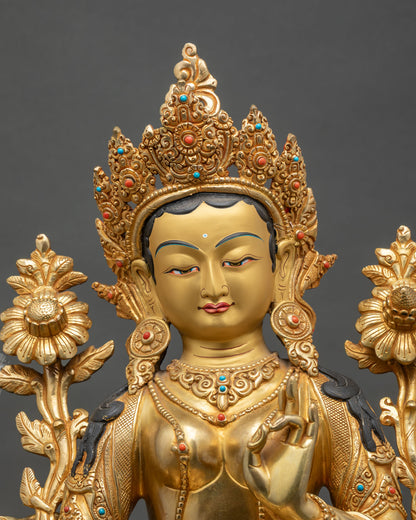 Close-up of Green Tara statue showing intricate copper and gold details
