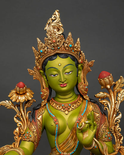 Close-up of Green Tara statue showing lotus pedestal, acrylic green paint, and gold gilded copper details