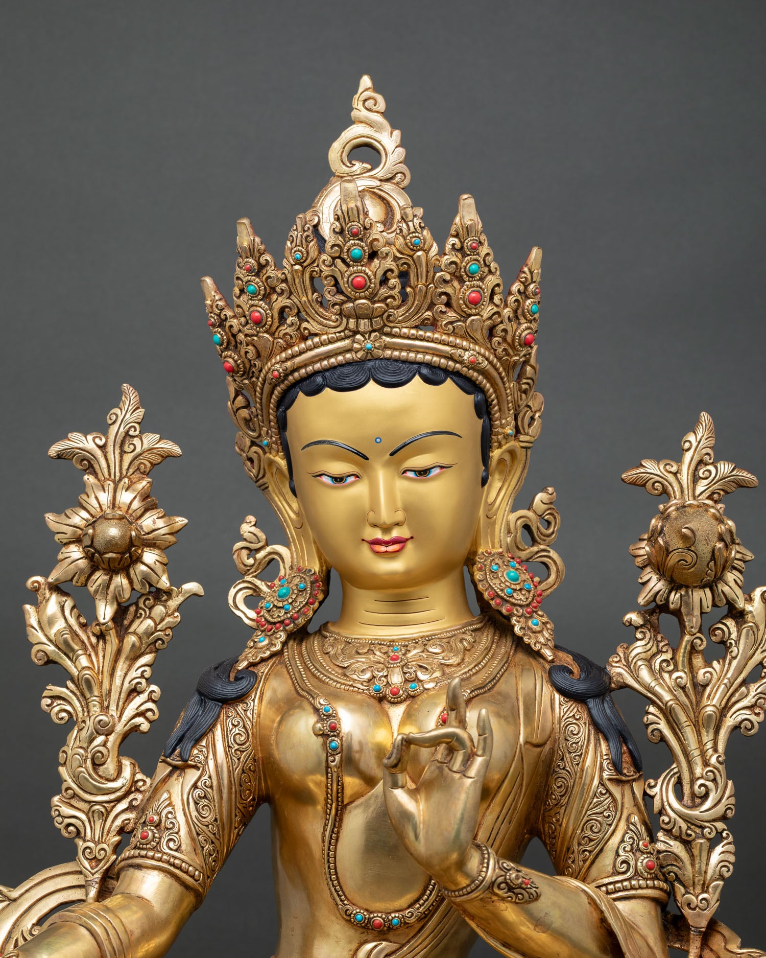 Close-up of Green Tara Statue showing the serene gold-painted face, jeweled crown, and detailed Newari artisan work.