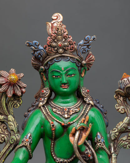 close-up of green tara statue with acrylic colors and handcrafted copper artwork