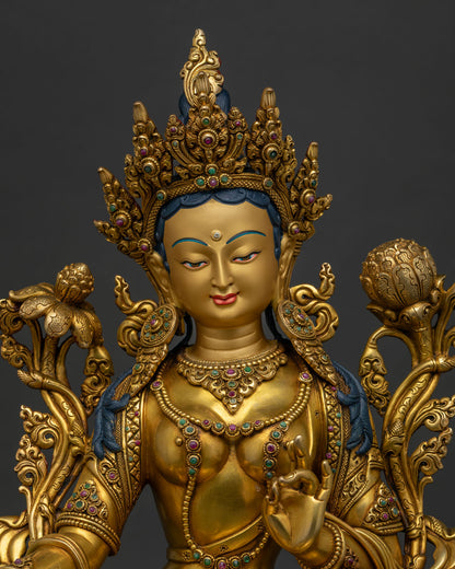 Close up of Green Tara Statue with gold gilding and gemstone inlay details