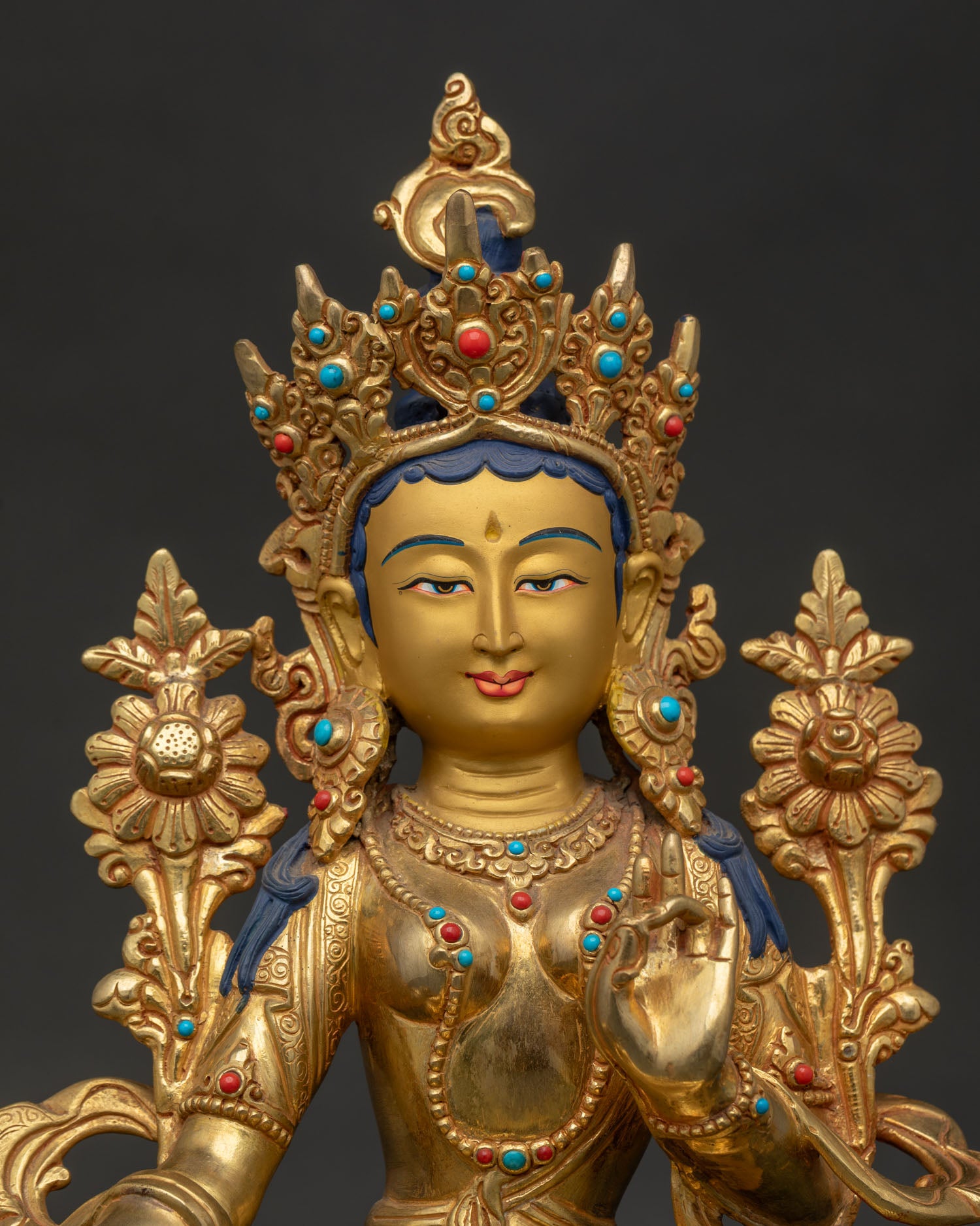 Close Up of Green Tara Statue with Gold Painted Face and Five Jeweled Crown.