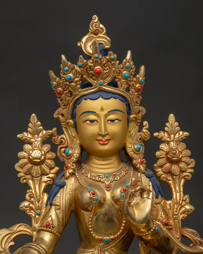 Close Up of Green Tara Statue with Gold Painted Face and Five Jeweled Crown.